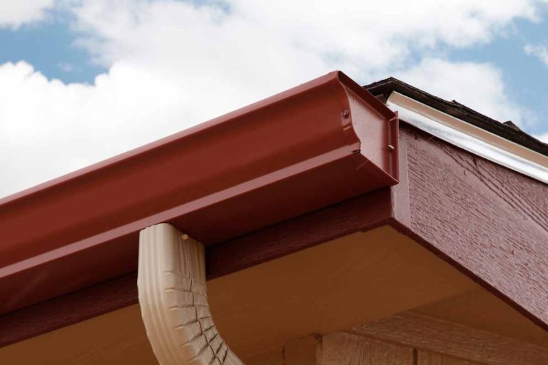 Close-up of a new K-style gutter installed on the edge of a roof.